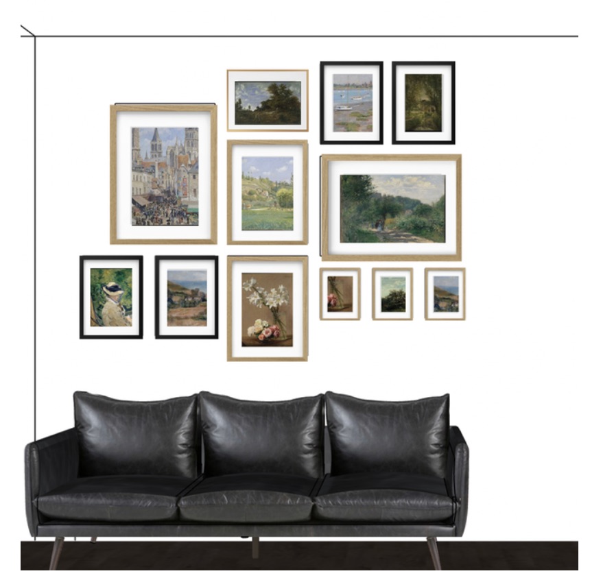 A gallery wall of framed landscapes above a black leather sofa.