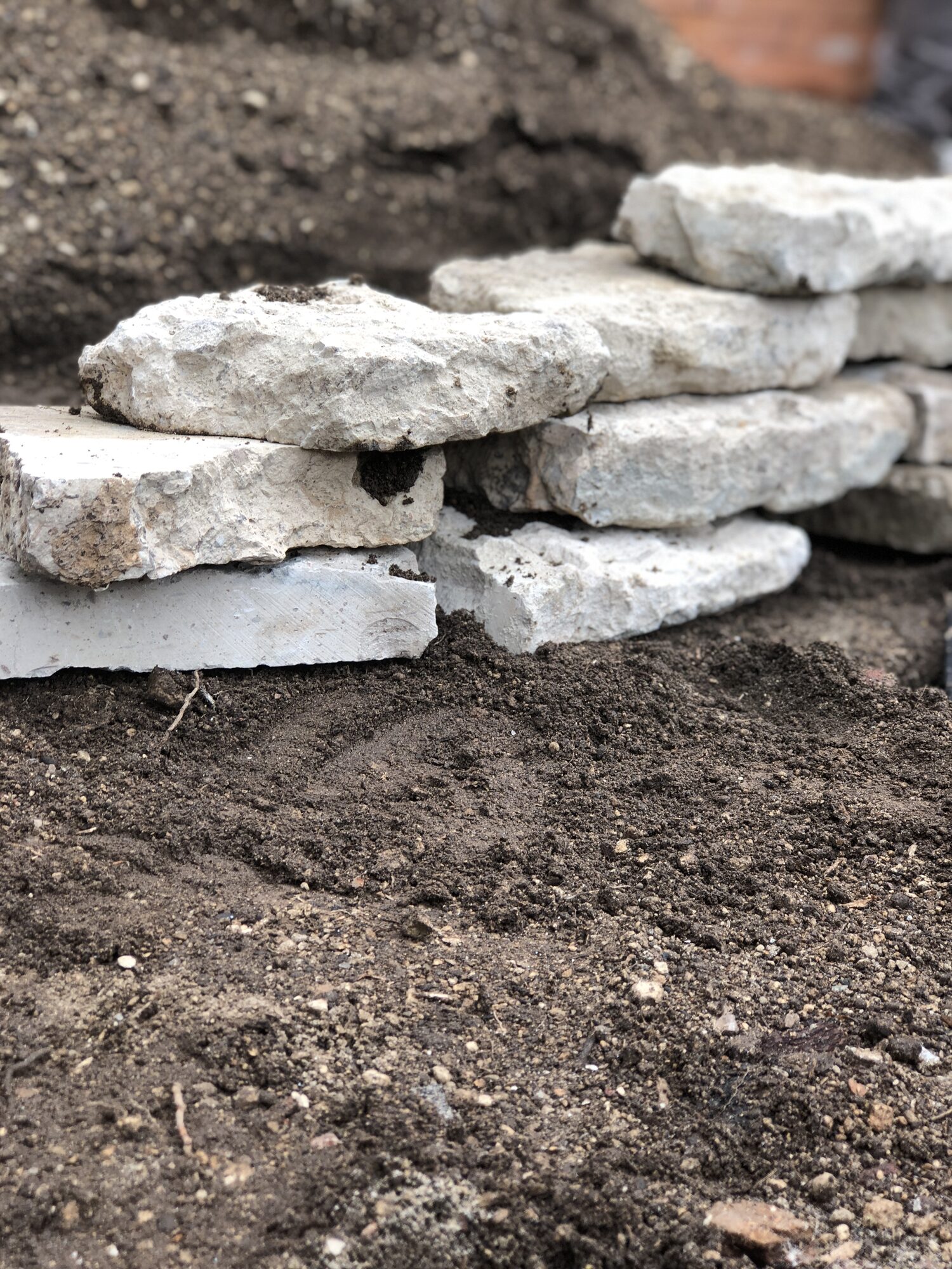 Stone and gravel laid across freshly worked soil.