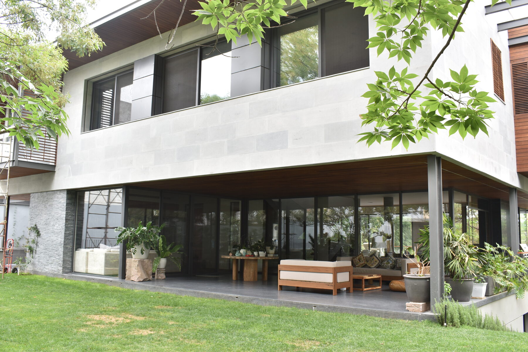 The house seen from the garden — a glazed pavilion within the landscape.